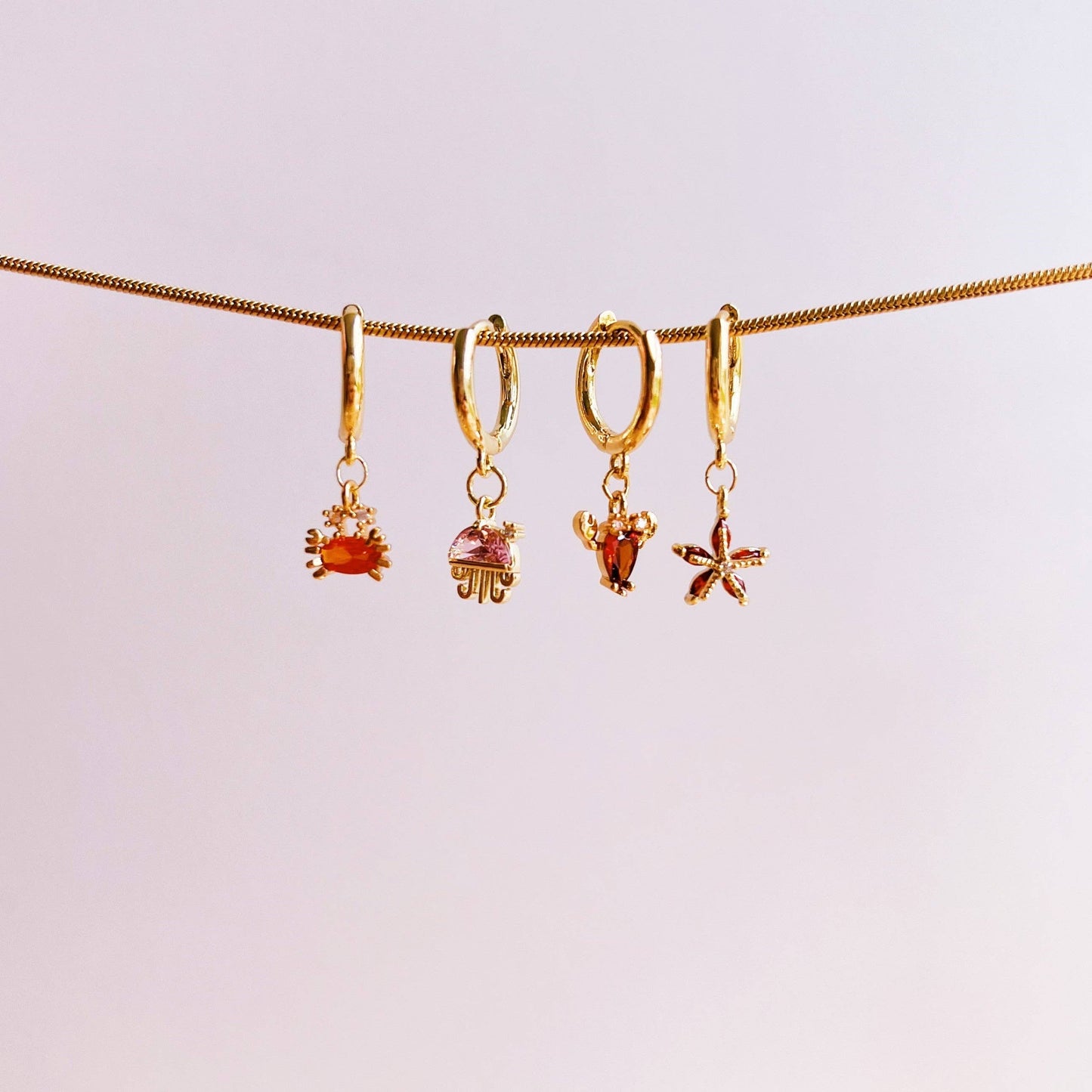 Boucle d’oreille étoile de mer brillante: Rouge / Doré - DupontDupont